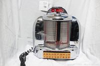 Front view of the retro jukebox style telephone with the rolodex phone book visible in the center, chrome finish and yellowed index buttons below.
