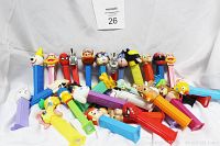 Photo showing over 30 assorted PEZ character dispensers including vintage and various cartoon characters in multiple colors.