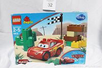 Box front showing LEGO Duplo Disney Pixar Lightning McQueen 11-piece set for ages 2-5, desert racing scene with cacti