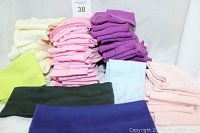 Photo showing multiple stacks of headbands in cream, pink, purple, light blue, lime green, black and navy blue colors.