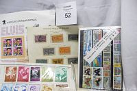 Photo showing a variety of stamps including American commemoratives, special delivery stamps in orange and purple, and sheets with portraits of various figures including Elvis Presley.