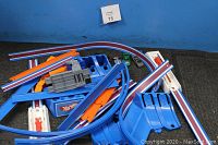 Top view of assorted Hot Wheels track pieces including curved and straight sections, launchers and connectors