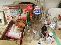 Image showing vintage Coca-Cola and Pepsi bottles, a 1000-piece Coca-Cola Santa Claus puzzle, collectible tins, and glass mugs.