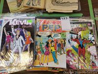 Photo showing three comic books, including Kevin Keller, Pep Comics, and Out of the Vortex issues, some in plastic covers.