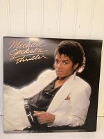Front cover of Michael Jackson Thriller vinyl album showing Michael Jackson in white suit.