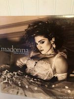 Front cover of Madonna's Like a Virgin vinyl album showing Madonna in a white lace dress with styled hair.
