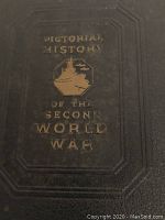 Close-up image of the front cover of one vintage book showing gold embossed text and an image of a battleship.