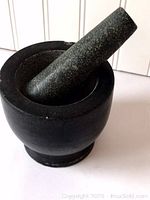 Front angle view showing the mortar with pestle resting inside the bowl
