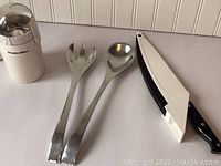 Photo showing the full set including the Proctor Silex coffee grinder, two pewter salad serving utensils (fork and spoon), and the Pampered Chef folding carving knife.
