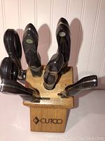 Front view of wooden Cutco knife block loaded with knives