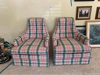 Front view of two upholstered armchairs with plaid pattern showing seat cushions, armrests, and backrests.