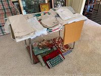 Overall view of multiple folded linens and napkins on a table, showing various colors and patterns