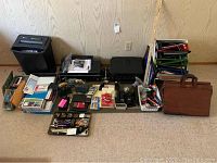 Full overview of all items including printers, paper shredder, office supplies, briefcase, and binders.