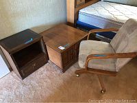 Photo showing all three pieces: wood nightstand, wood end table, and upholstered swivel chair near bed