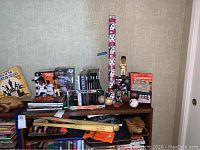Full view of various Giants baseball memorabilia on table including bats, books, baseballs, mitt, and bobbleheads