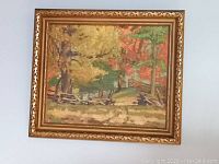 Framed oil landscape painting with autumn trees and rustic fence, signed and dated 1942.