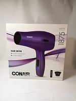 Front of box showing Conair 1875W hair dryer in purple with product details and brand name.