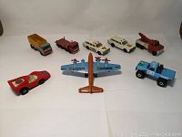 Photo showing all eight vintage Hot Wheels vehicles arranged in two rows on a white background.
