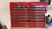 Full frontal view of the red Husky toolbox showing multiple drawers and chrome handles.