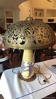 Full view of vintage lustre lamp displaying ornate metal shade and porcelain base with bird design.