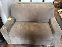 Front view of gray microfiber loveseat showing seat cushion and arms