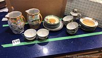 Full display of all ceramic pieces and sugar shaker on countertop
