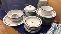 Photo showing entire Dansk Ware dinnerware set including plates, bowls, and covered sugar or serving bowl stacked on a counter.