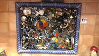 Frontal photo of framed glass and ceramic mosaic artwork showing colorful fragmented glass and ceramic pieces arranged abstractly.