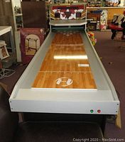 Full length view of Harvard Shuffle Bowl game table showing gameplay surface with ridewood laminate and arcade control panel at end