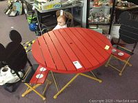 Full view of round red table and two Mickey Mouse-themed chairs showing design and condition.