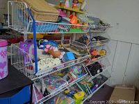 Full view of the first white wire display rack filled with various items to show shelf style and condition