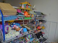 Nine white wire shelves filled with various children's toys including toy vehicles, activity toys, and craft kits.