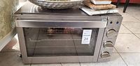 Full view of stainless steel oven showing glass door and handle