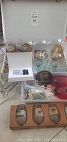 Overall box view showing assorted bar glasses and supplies including martini glasses, mugs, and shot glasses.