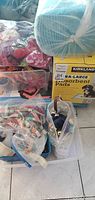 Photo showing varied pet collars, leashes, and pet clothing, as well as packaged absorbent pads box in background.