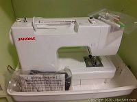 White Janome sewing machine on base tray with logo visible
