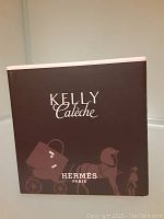 Front of Hermes Kelly Caleche box with branding and logo.