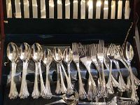 Full set of F.B. Rogers silverplate flatware including knives, forks, spoons, and serving pieces in a wooden box with black velvet lining.