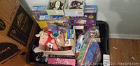 View of the assortment of boxed toys including Barbie, Star Wars, Spiderman Legos, Techno Gears, and American Airlines playset.