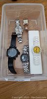 All six watches displayed in plastic container