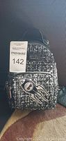 Front view of Karl Lagerfeld tweed handbag with space rocket patch and MaxSold auction tag attached