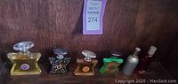 Six perfume bottles arranged on a shelf