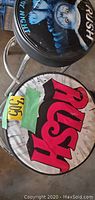 Photo showing the top of both Rush band barstools, one with an owl design and one with red Rush lettering