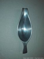 Top-down view of the metal alloy gravy boat with smooth, curved design and integrated handle.