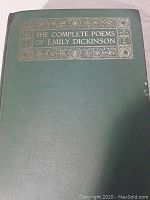 Front cover of the book showing green hardcover with gold embossed title and decorative border, slight wear visible.