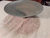 Top view of the wide, shallow pottery bowl showing smooth interior and muted gray glaze.