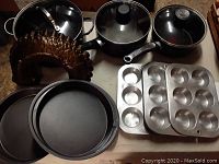 Overview of assorted pots, pans, baking tins including bundt mold and muffin tins