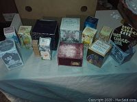 Photo of 14 Avon collectible items still in original boxes