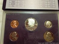 1986 US proof coin set with five coins mounted in purple insert case with specification card.