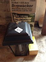 Sears 70 Watt Bugwacker electronic insect killer shown with original box on concrete floor.